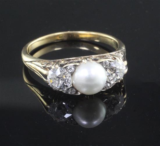 An early 20th century gold, split pearl and diamond set three stone ring, size P.